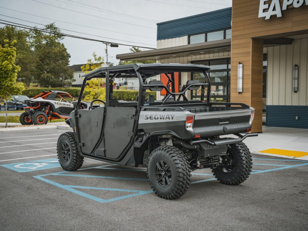 Gray Segway off-road utility vehicle parked in a handicapped parking space outside a modern building.
